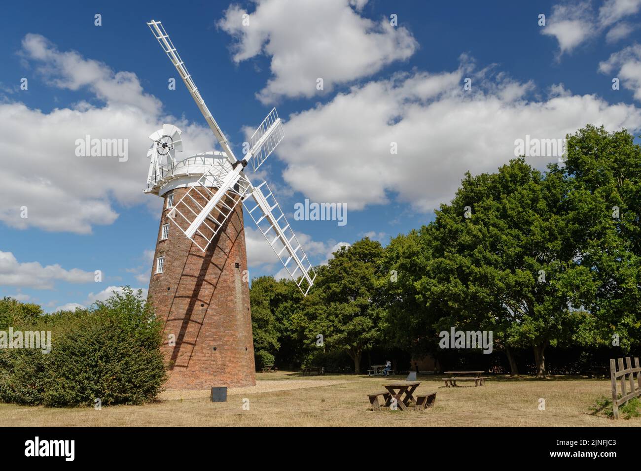 Fendick's Mill known as Dereham Windmill, a restored grade II list tower mill with a boat shaped cap and six bladed fantail. Stock Photo