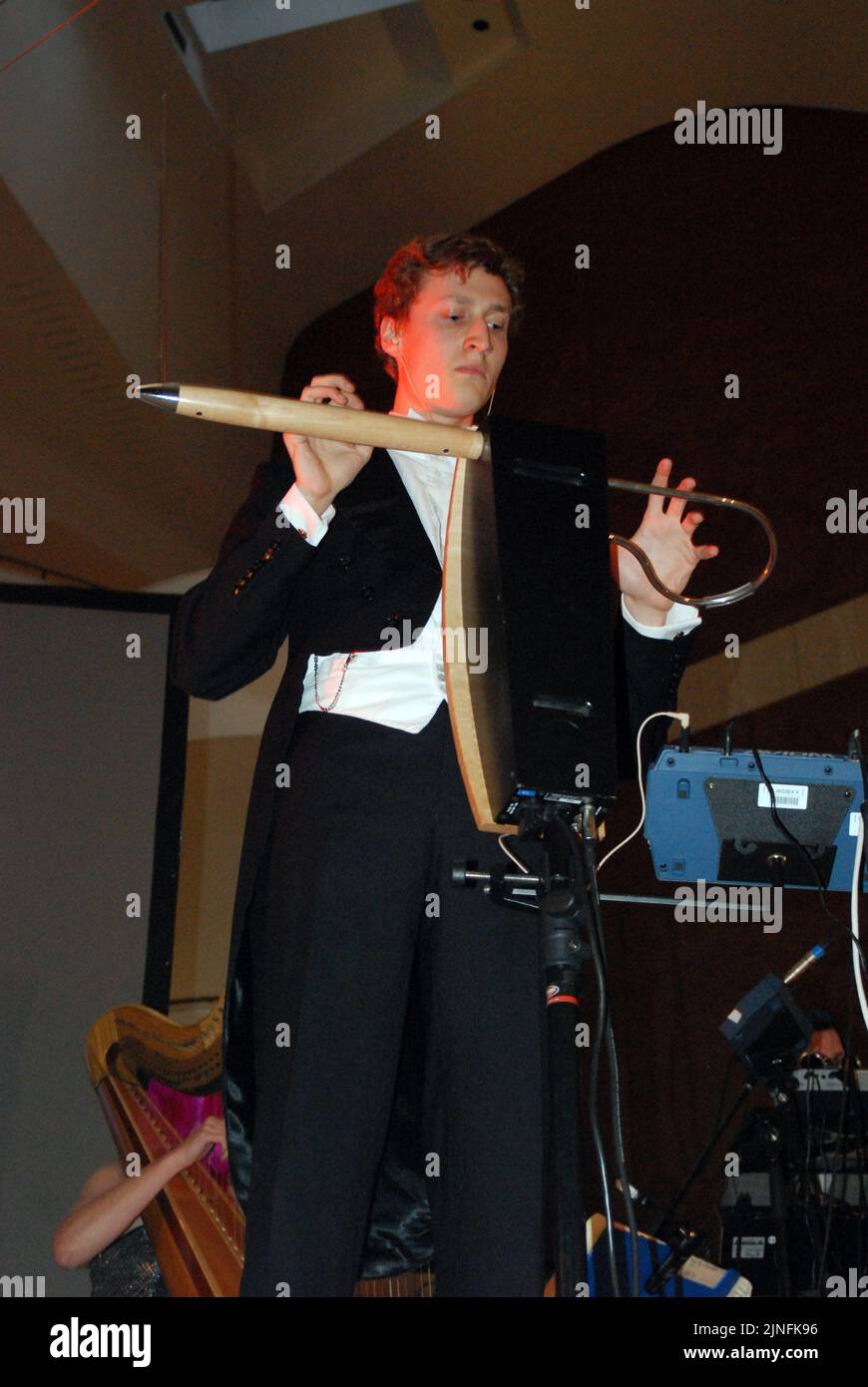 British musician, Charlie Draper, playing the theremin, on stage at the British Library, London while performing with the Radio Science Orchestra 2011 Stock Photo