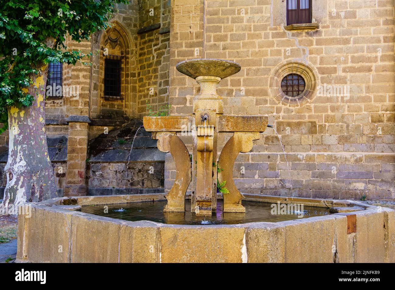 Medieval stone fountain next to the Romanesque church of the old village of Barco de Avila, Spain. Stock Photo