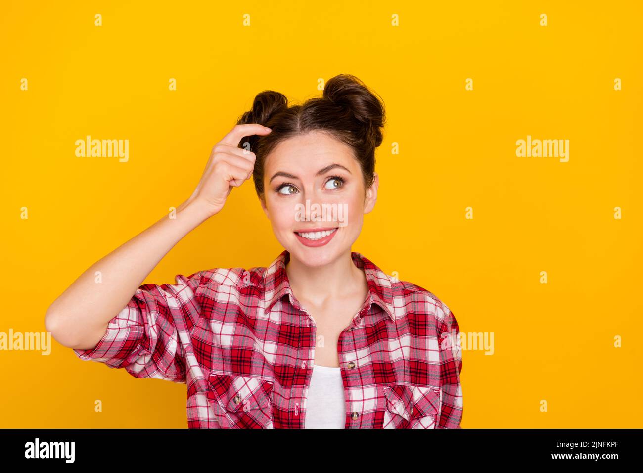 Photo of positive pretty lady finger scratch head look interested empty space isolated on yellow color background Stock Photo