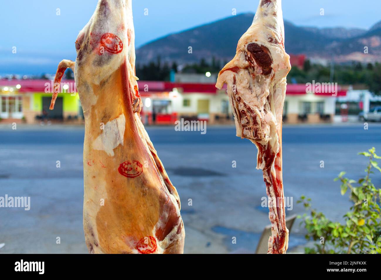 Fresh meat hanging in a butcher shop Stock Photo