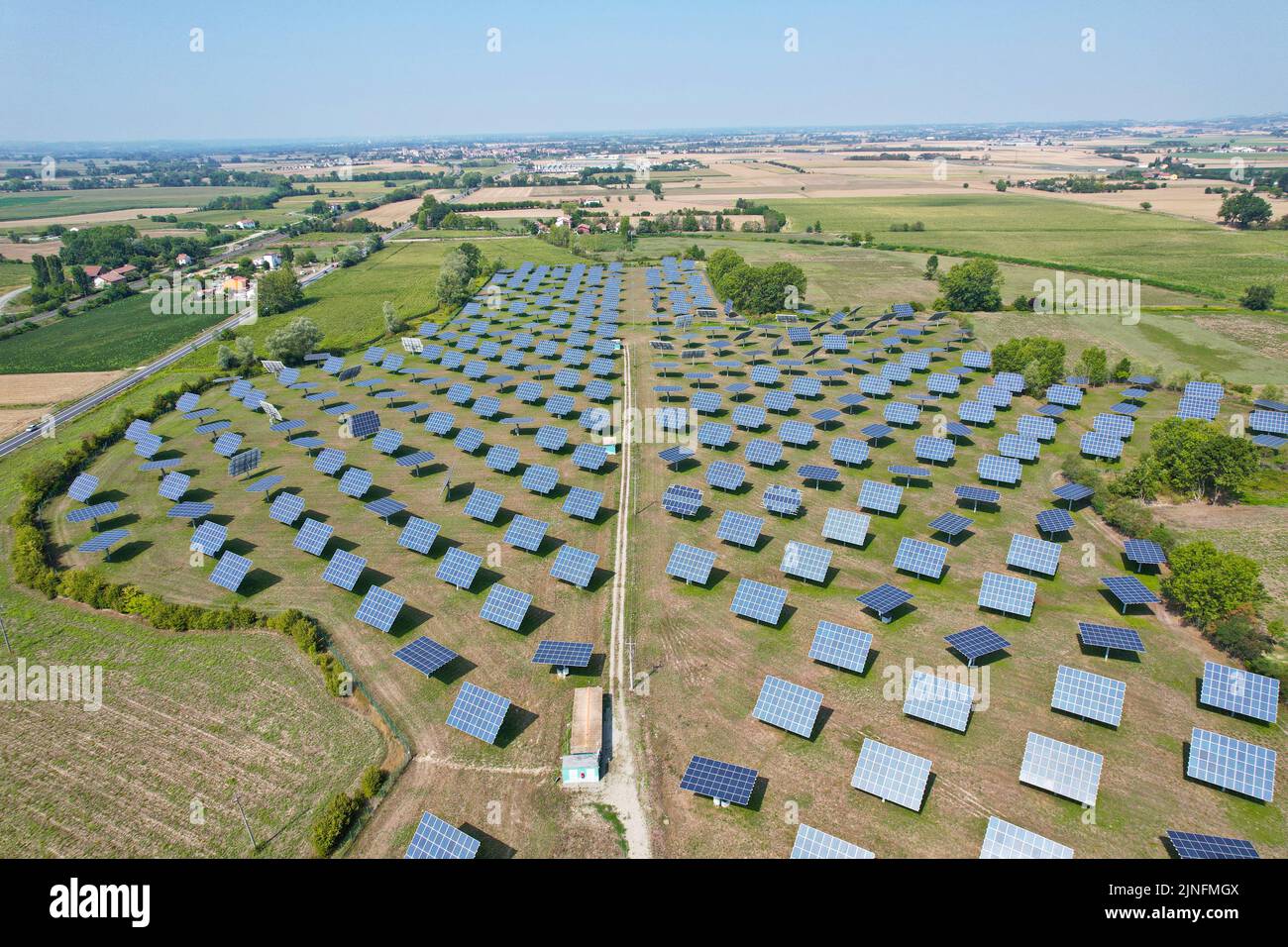 Silicon photovoltaic panels with defective single-axis tilted track system In a small solar power plant. Alessandria, Italy - August 2022 Stock Photo