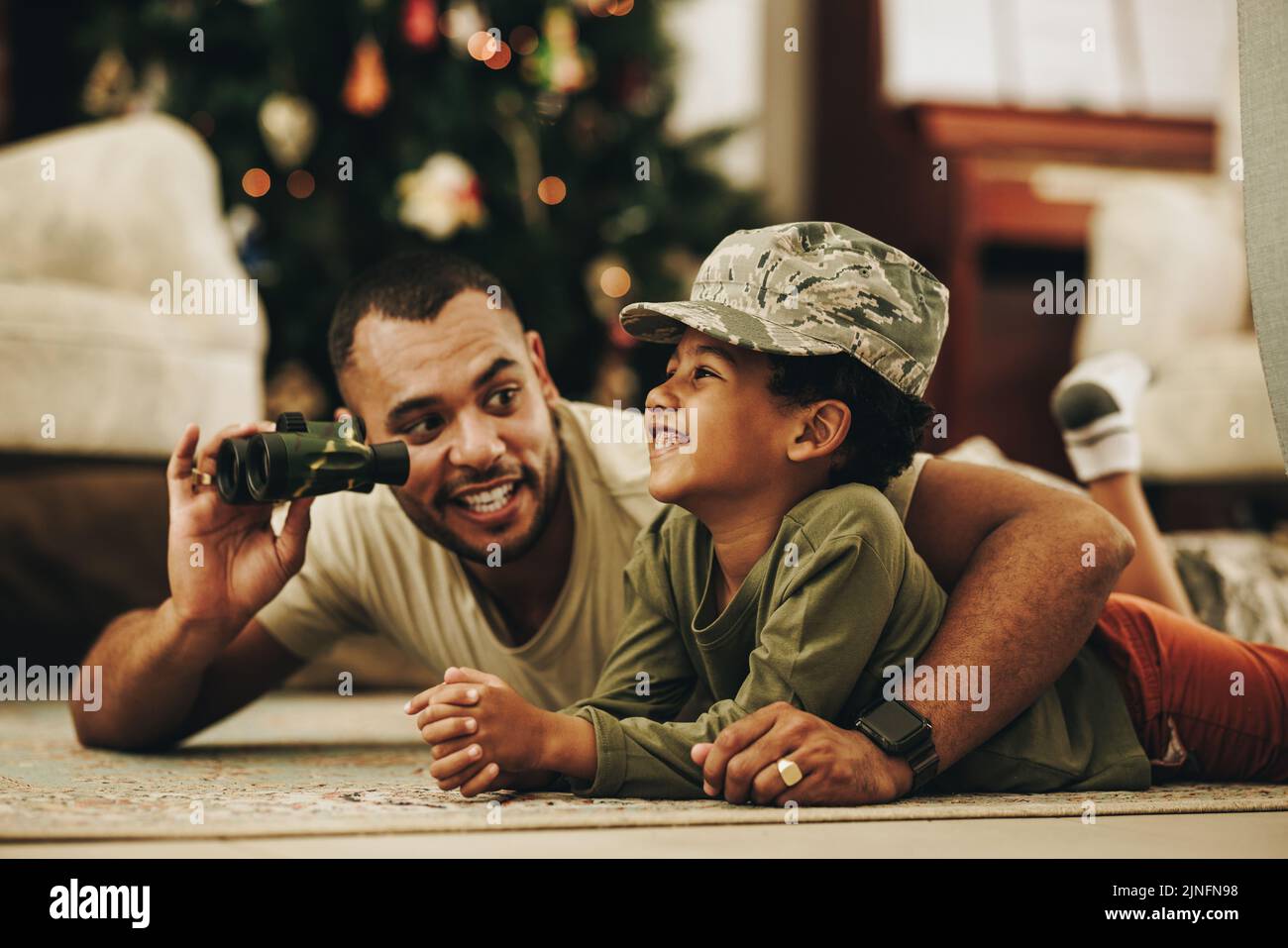 Happy military dad spending some quality time with his son at Christmas. Army soldier spending the holidays with his child after deployment. Father an Stock Photo