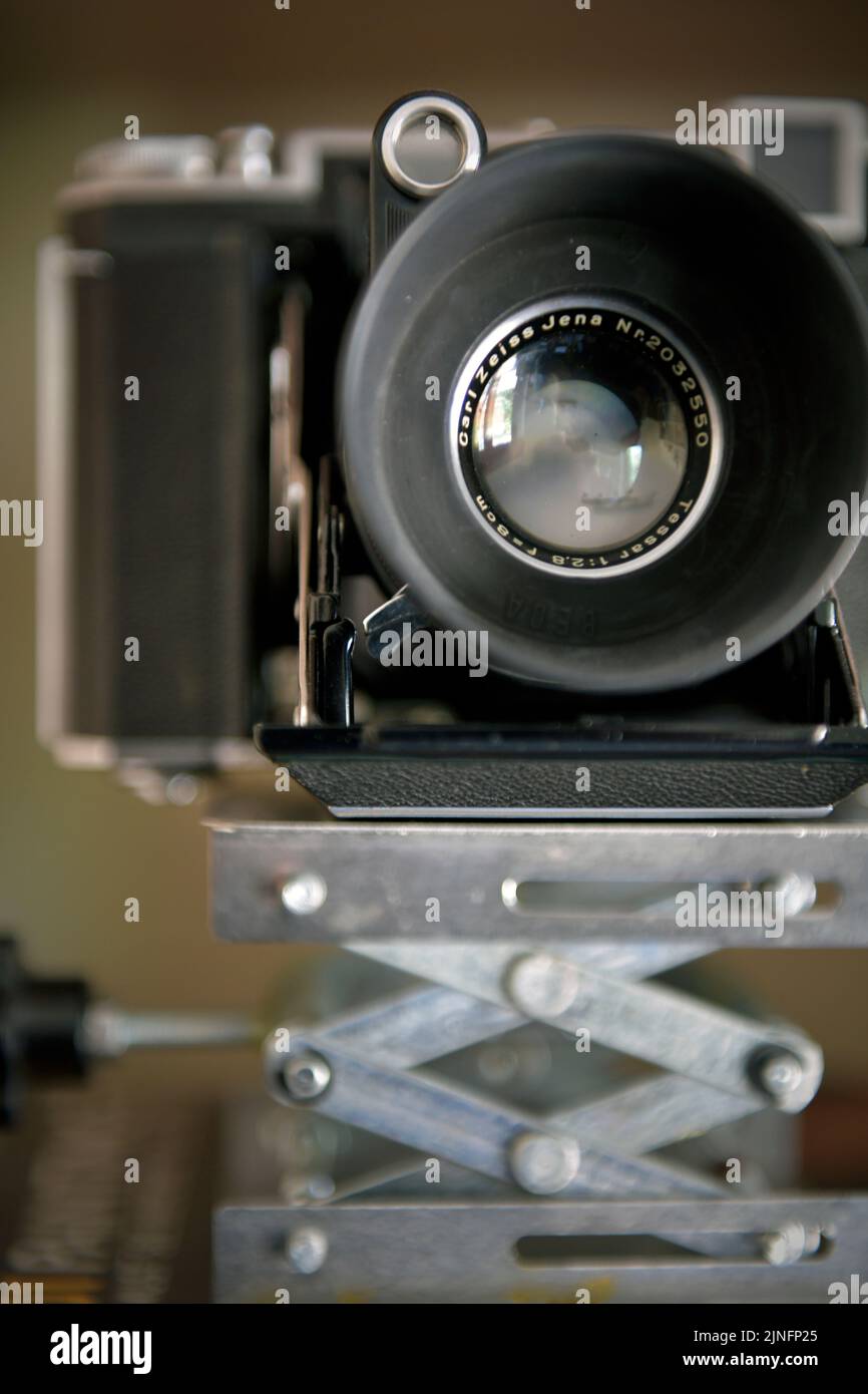 vintage zeiss ikon folding film camera on rising  scissor lift platform Stock Photo