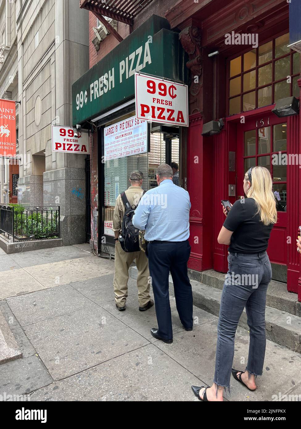 99¢ pizza is always a draw at lunchtime in midtown Manhattan. Stock Photo
