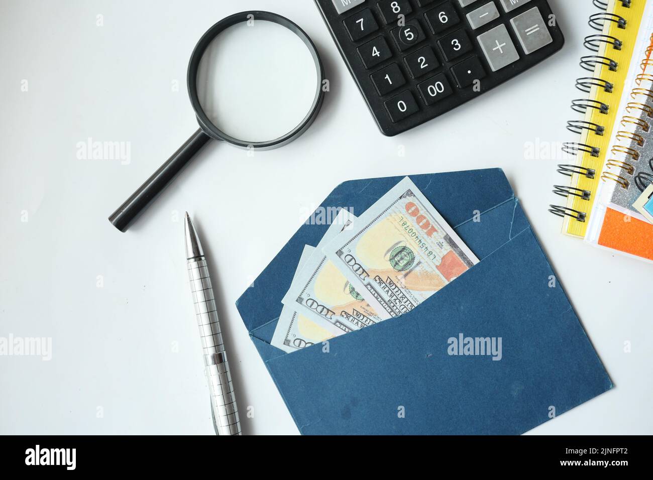 100 dollar cash in a envelope on a desk  Stock Photo