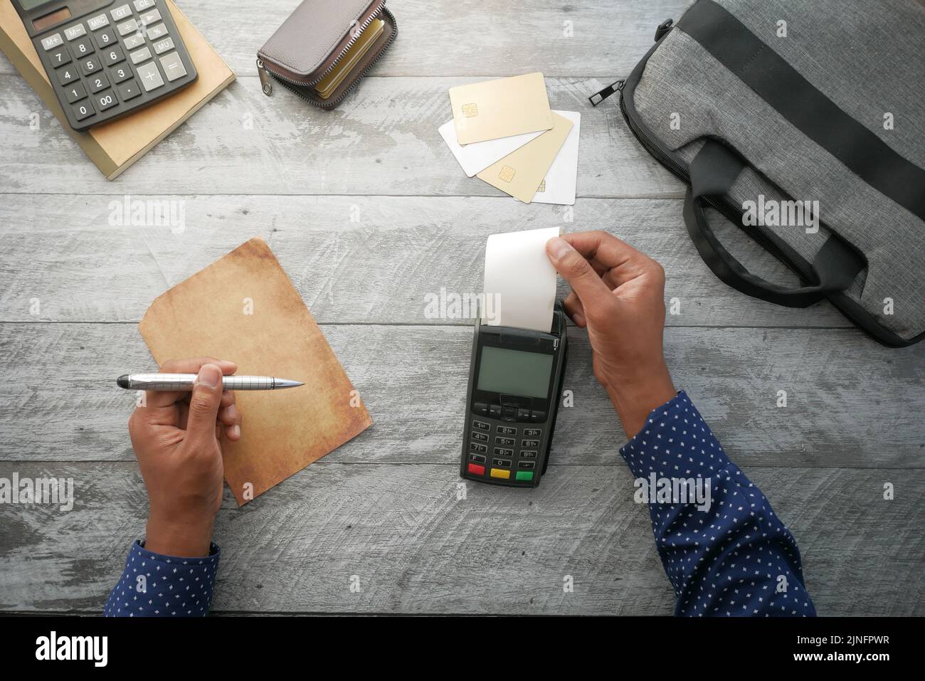 top view of POS machine and long roll paper on table  Stock Photo
