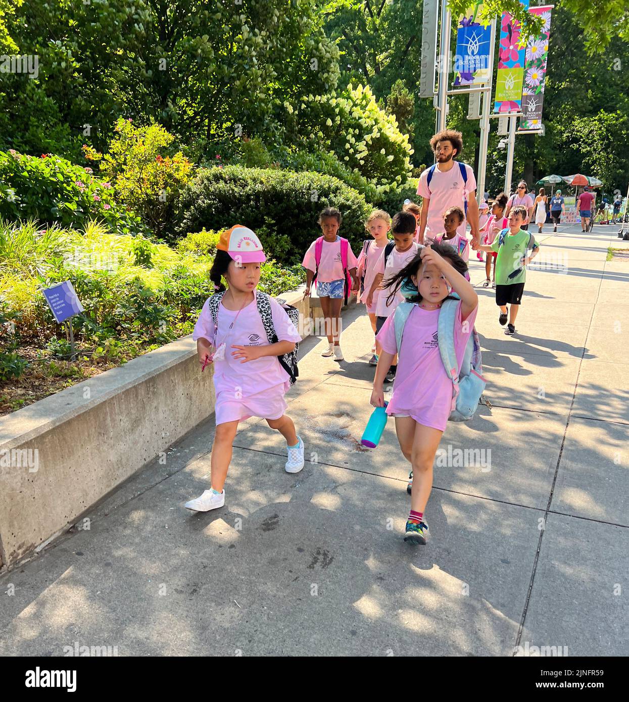 Day camp group of children walk in pairs from the Brooklyn Botanic Garden on Eastern Parkway in Brooklyn, New York Stock Photo