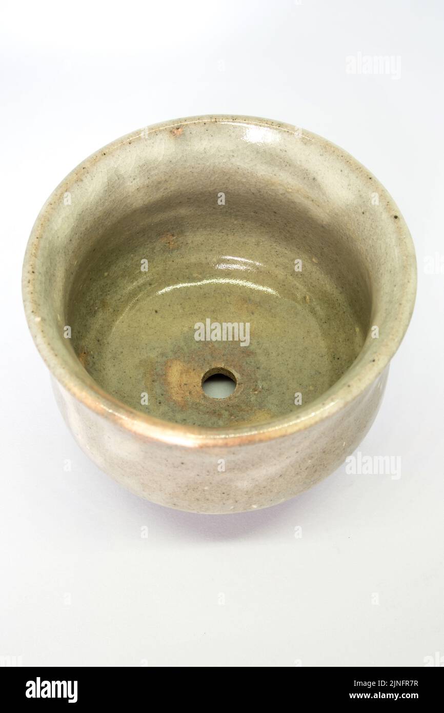 The ceramic cup has been adapted for planting small pot plants Stock