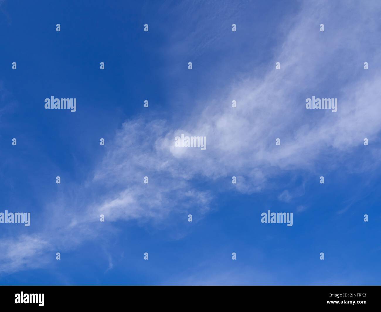 Fluffy clouds floating scattered across the sky Stock Photo