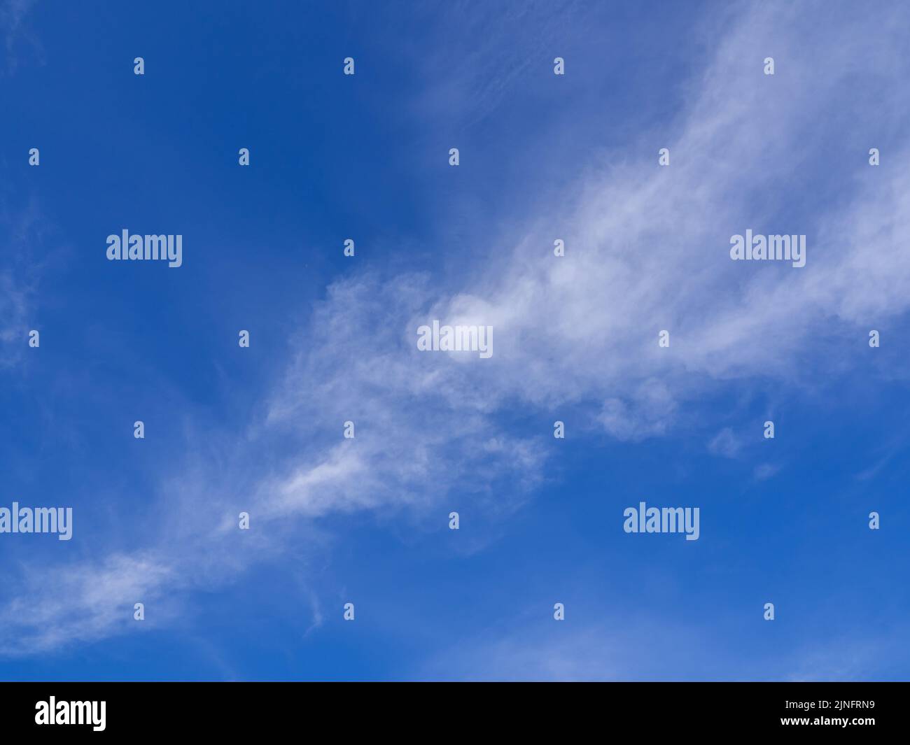 Fluffy clouds floating scattered across the sky Stock Photo