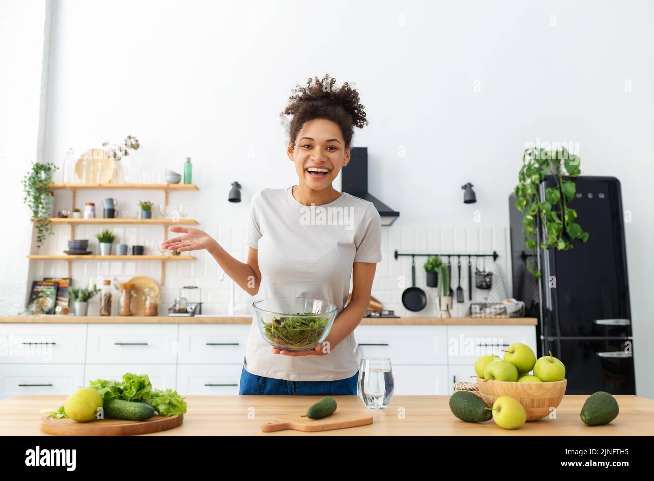 young woman using webcam to record video of cooking healthy food Healthy lifestyle concept online webinar Stock Photo