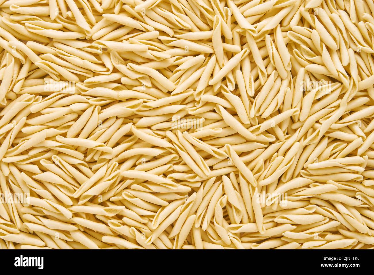 Food background. Dried trofie pasta from Liguria. Short twisted pasta, top view Stock Photo