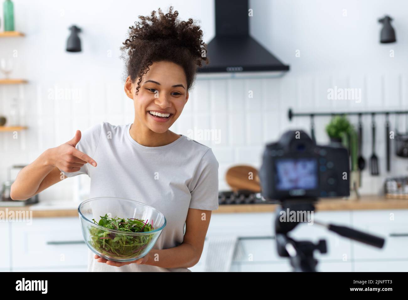 Healthy diet eating Smiling woman food blogger cooking healthy food in home kitchen Healthy lifestyle Stock Photo