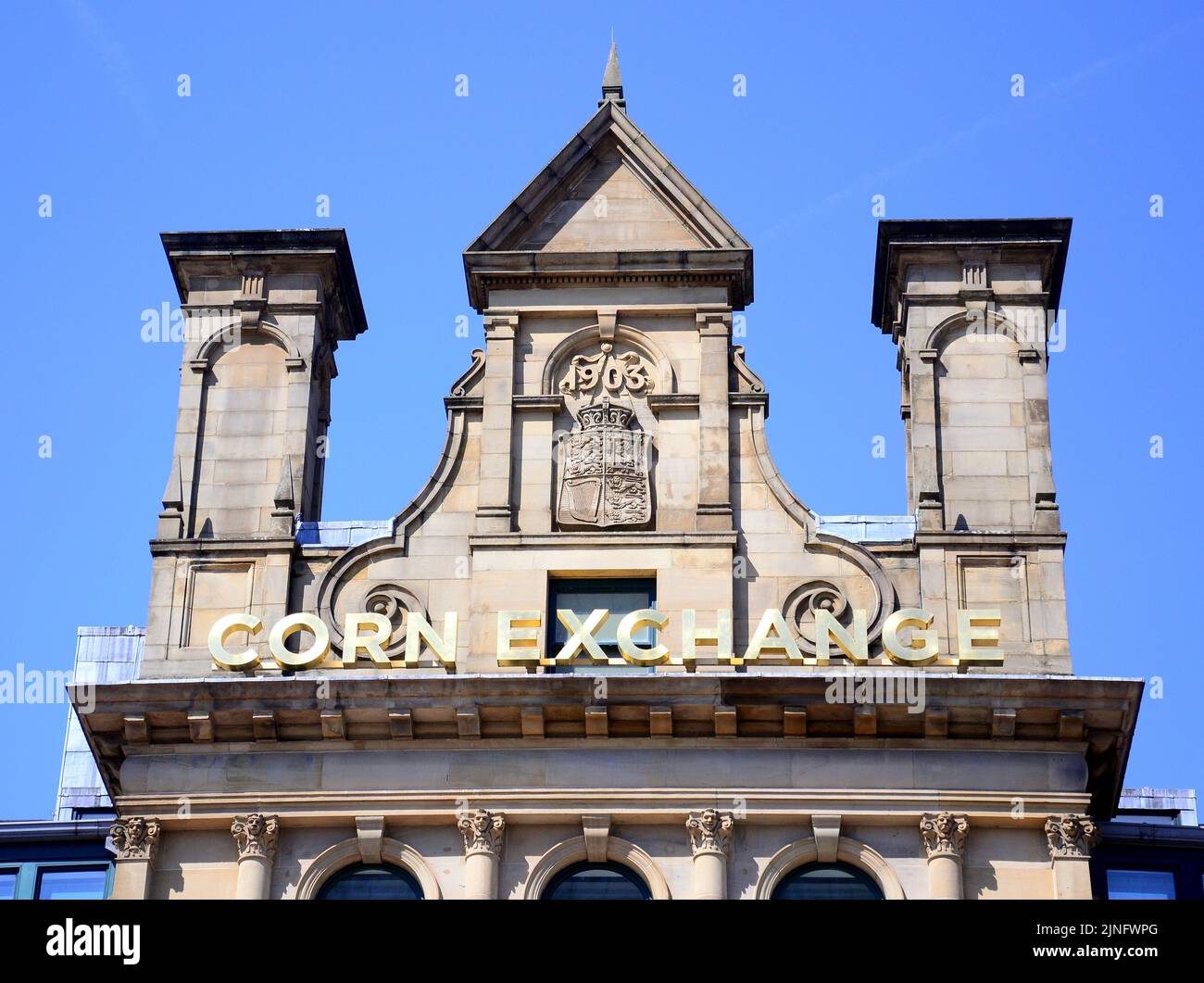 An exterior sign or signage or logo on the Corn Exchange, a grade II listed building, in central Manchester, United Kingdom, British Isles. Stock Photo