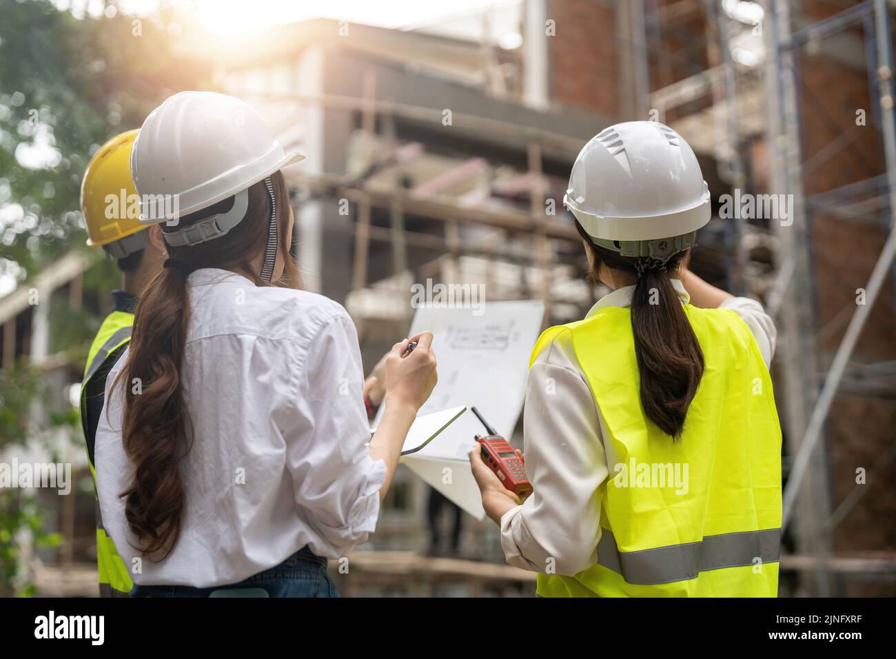 Engineer and Architect working at Construction Site with blue print, Construction concept Stock Photo