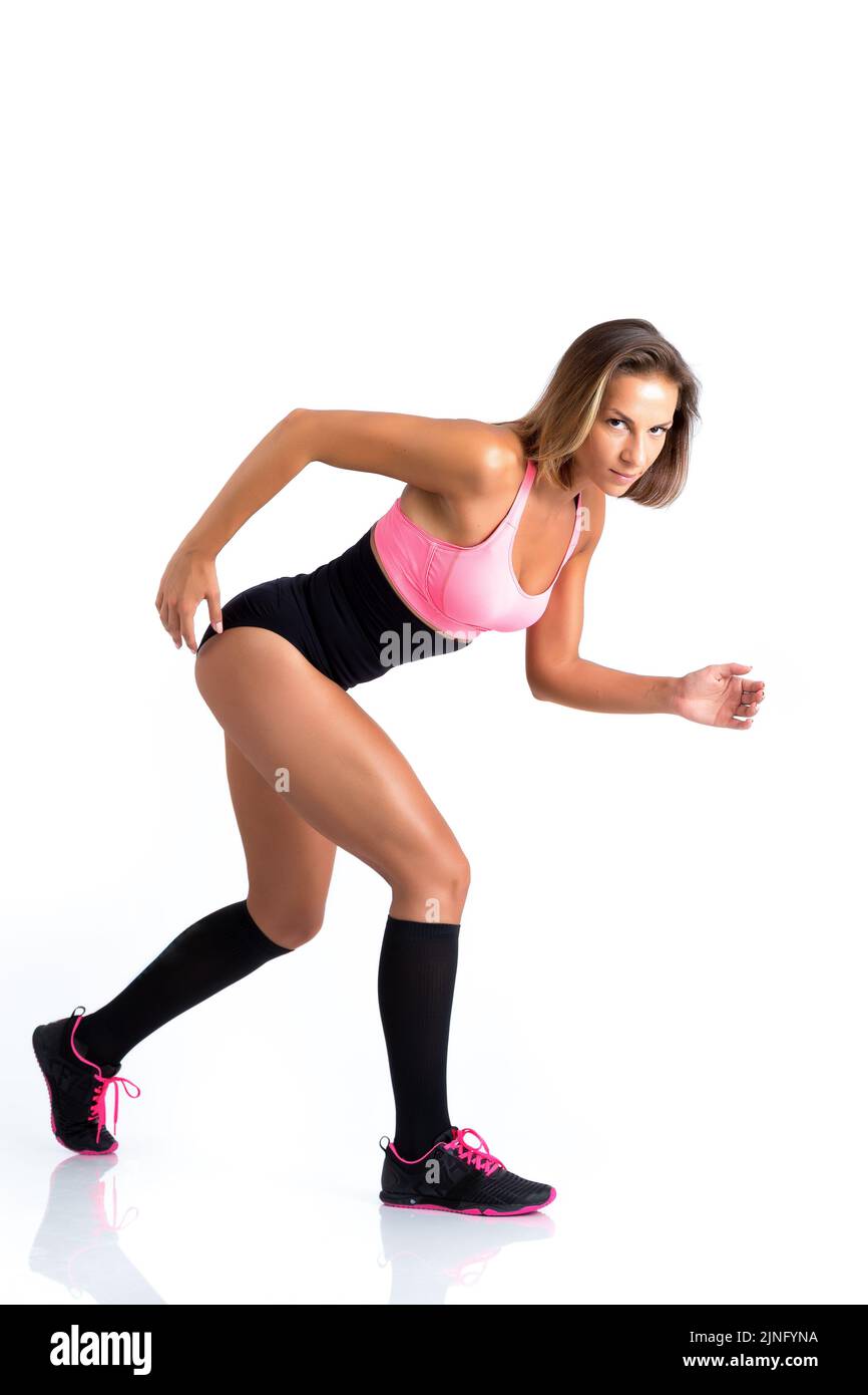 An athletic female doing exercises on white background Stock Photo