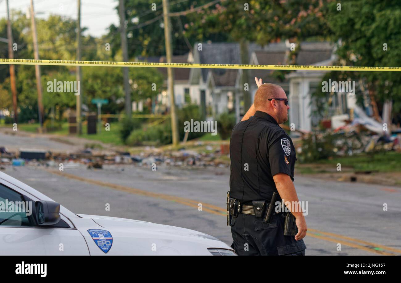 Evansville, Indiana, USA. 11 Aug 2022. An Evansville Police officer walks toward the site where a house exploded the previous day, killing at least three people and damaging 39 other homes in the area. (Credit: Billy Suratt/Apex MediaWire via Alamy Live News) Stock Photo