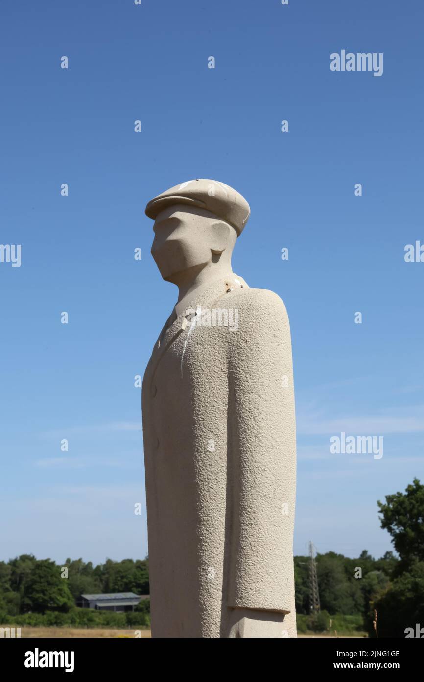 Regiment of Trees, stone soldiers carved by Patrick Walls stand in a grid, Langley Vale