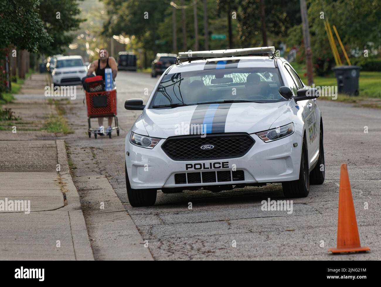 Evansville, Indiana, USA. 11 Aug 2022. An Evansville Police Department cruiser drives around a man pushing a shopping cart near the site where a house exploded the previous day, killing at least three people and damaging 39 other homes in the area. (Credit: Billy Suratt/Apex MediaWire via Alamy Live News) Stock Photo