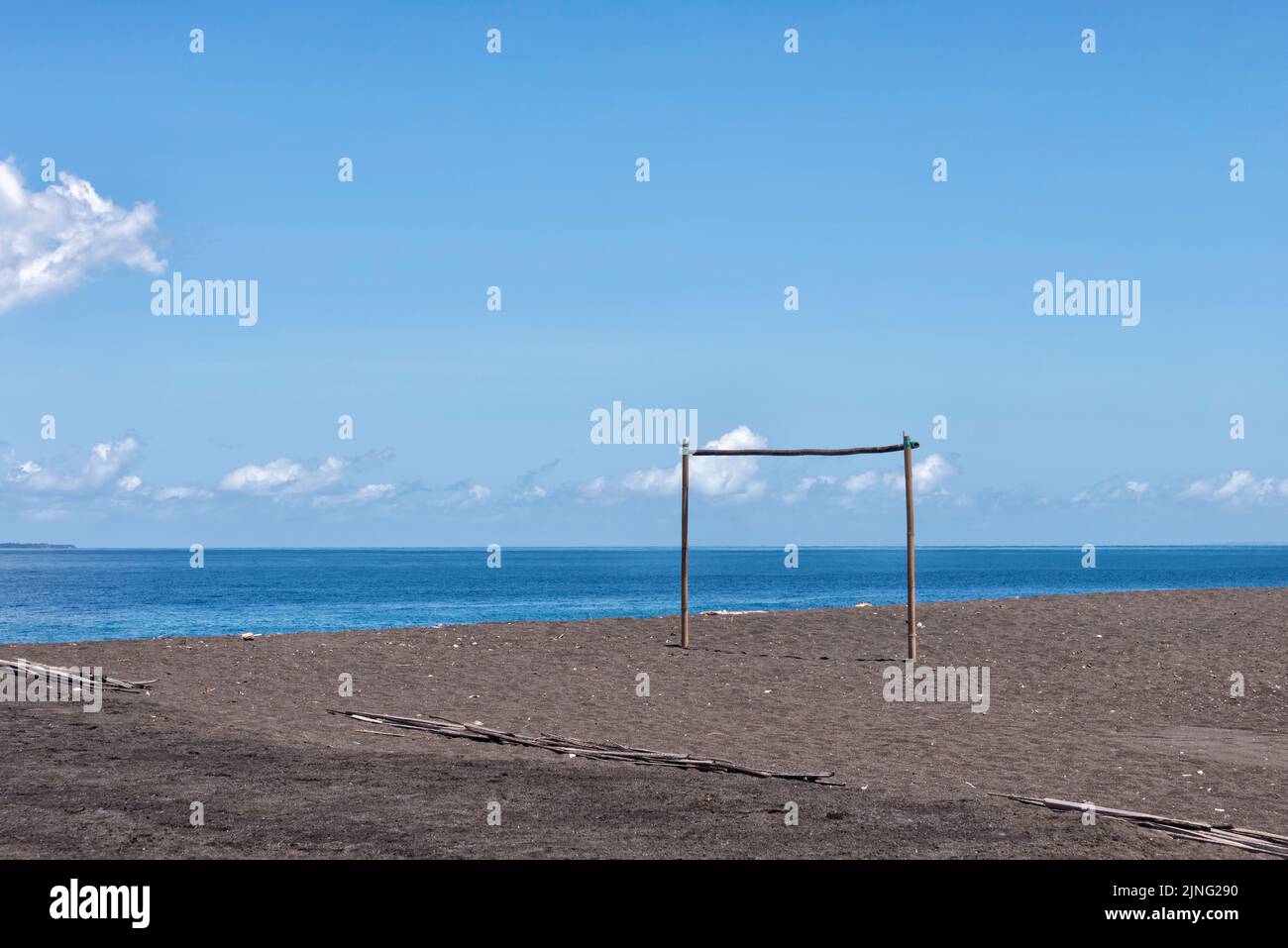 Goalpost on black volcanic sand beach Stock Photo