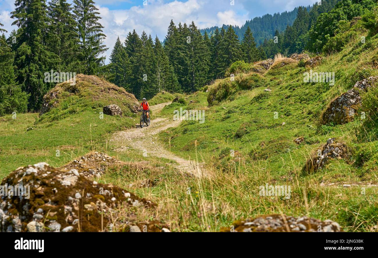nice senior woman riding her electric mountain bike in the Bregenz Forest mountains near Hittisau, Vorarlberg Austria Stock Photo