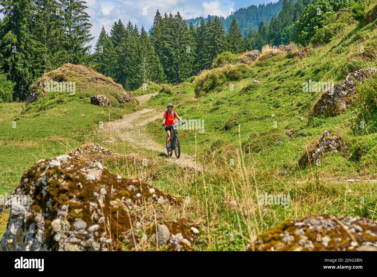 nice senior woman riding her electric mountain bike in the Bregenz Forest mountains near Hittisau, Vorarlberg Austria Stock Photo