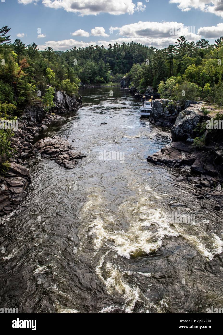 Rapids on the St. Croix River and the Taylors Falls Princess riverboat docked along the shoreline. Stock Photo