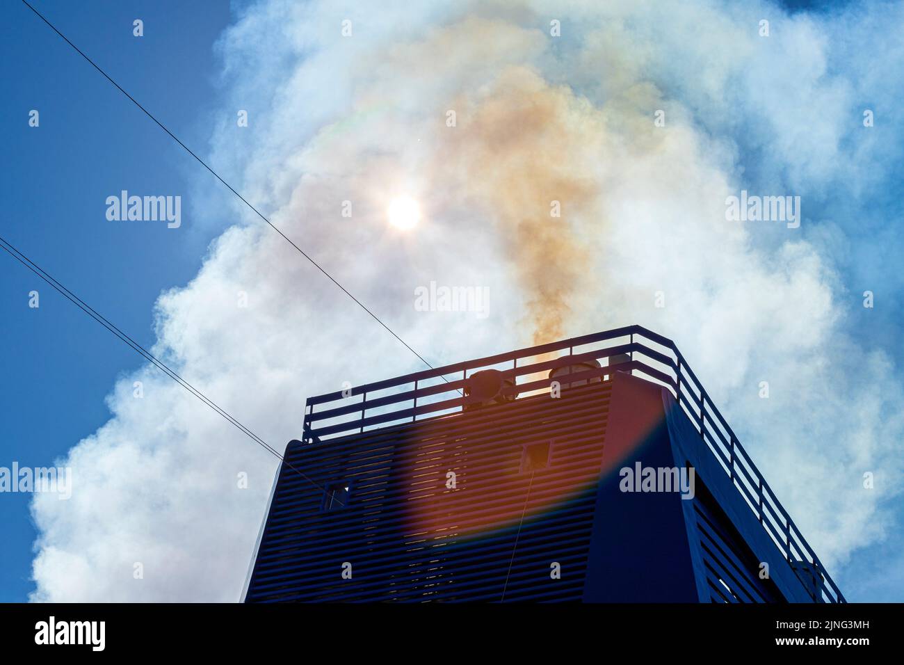 Smoky emissions from the exhaust pipes in the funnel of a large cruise ship Stock Photo