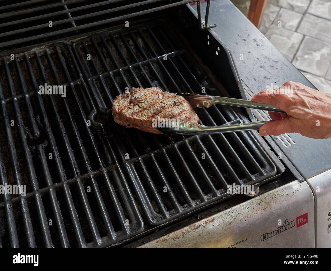 Filet steak grilling on a home barbecue grill for a dinner meal. Stock Photo