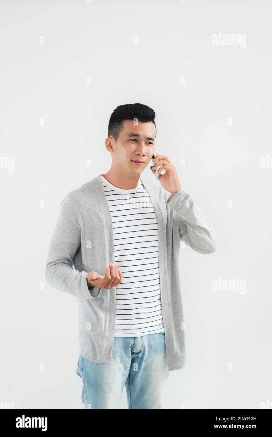 Portrait of young man discussing various issues on the phone Stock Photo