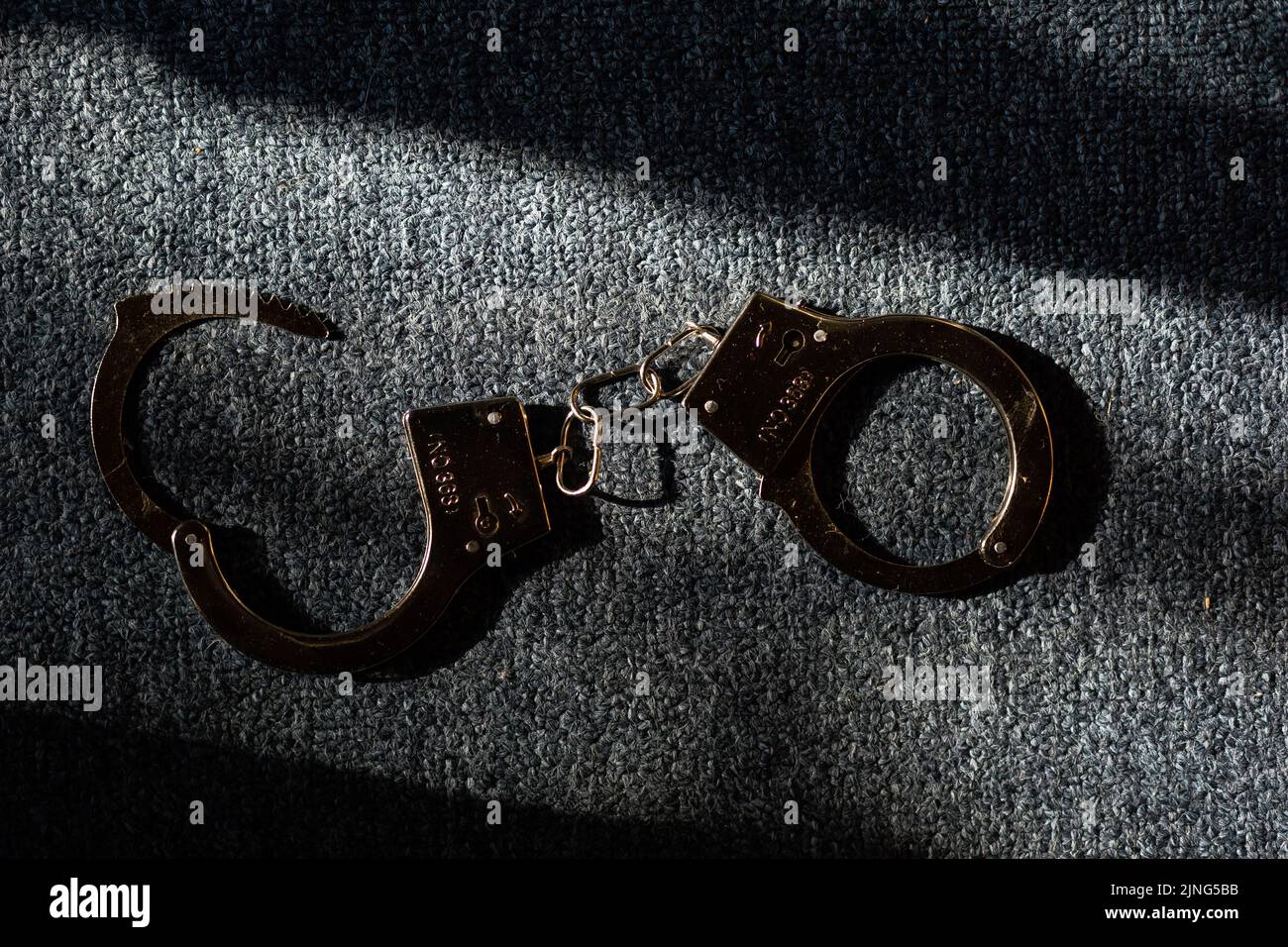 Classic chain handcuffs on black background Stock Photo Alamy
