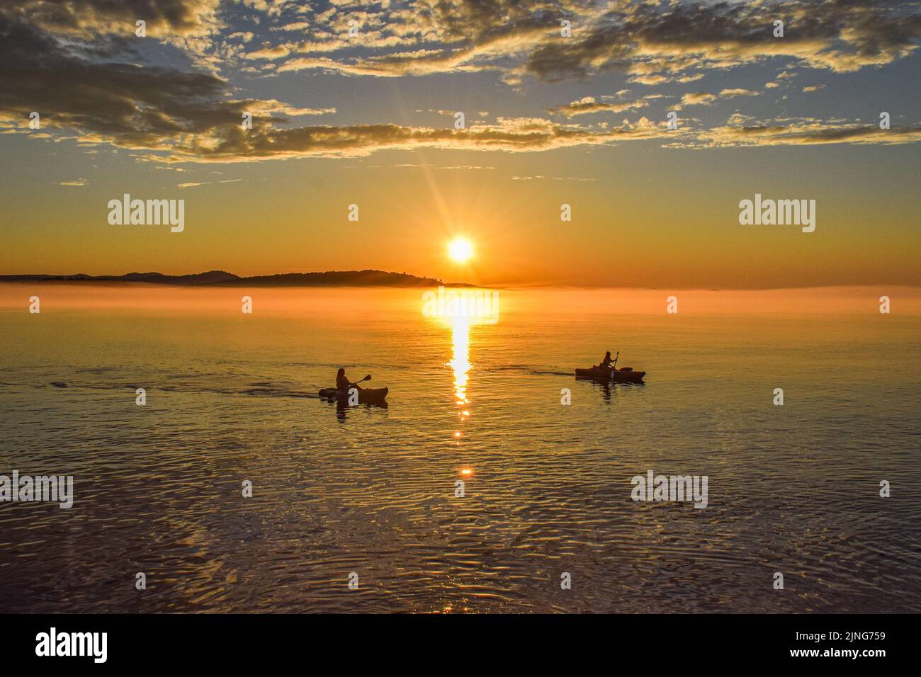 A silhouette of boats on the lake on the sunset Stock Photo - Alamy
