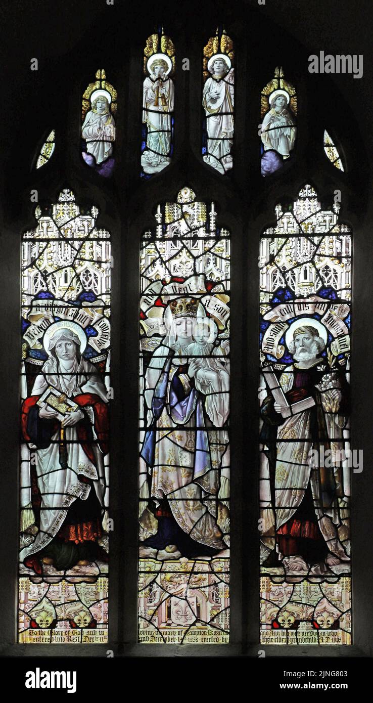 Stained glass window by Percy Bacon & Brothers depicting The Blessed Virgin Mary, St Anne and St Joseph, Mawgan-in-Pyder, Cornwall Stock Photo