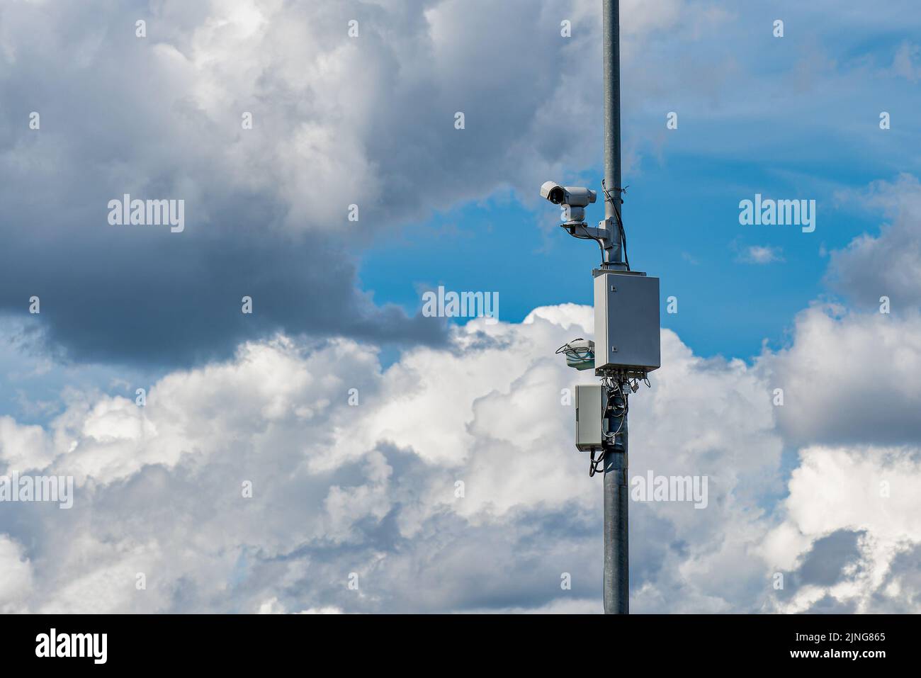 Security control camera or CCTV on cloudy sky background Stock Photo
