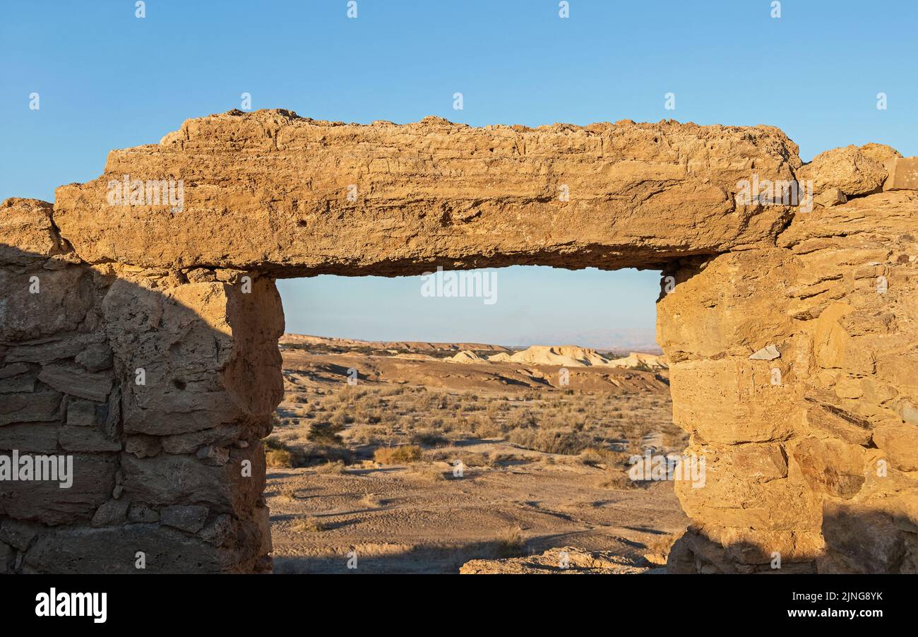 setting sun lights up the huge lintel stone over a doorway at the Khirbet Moah Nabatean era ruins on the Spice Route in the Arava Desert in Israel Stock Photo