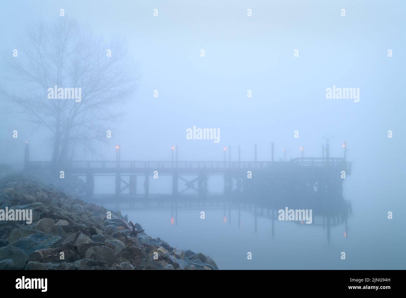 Fishing Pier River Fog. Fog blankets the No. 3 Road fishing pier in Richmond in the early morning. Stock Photo