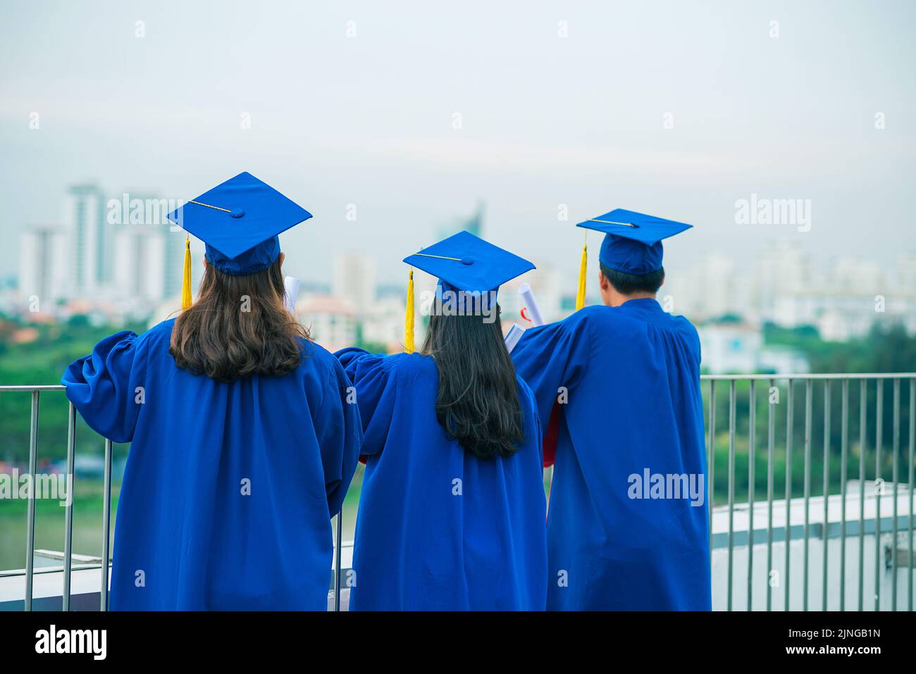 Proud graduates in blue gowns hi-res stock photography and images - Alamy
