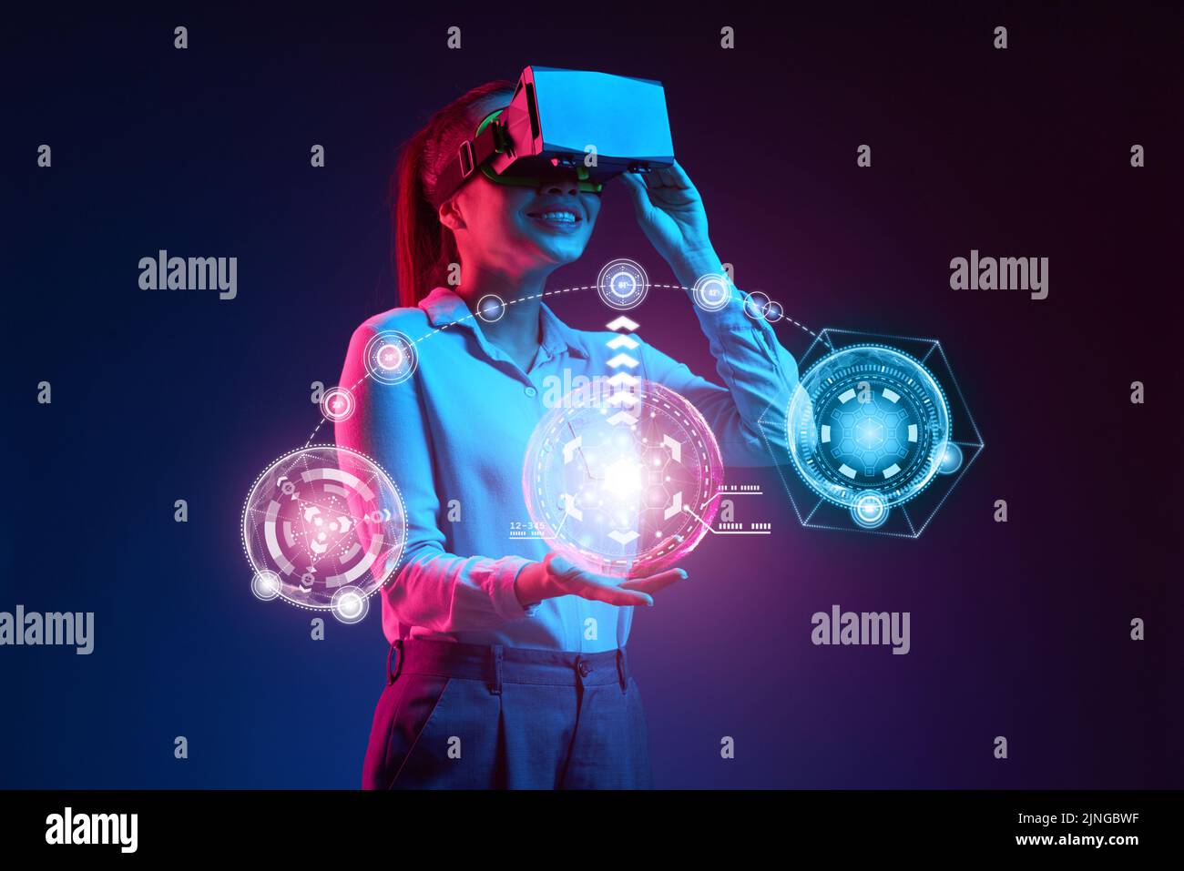 Happy young business lady using virtual reality interface Stock Photo