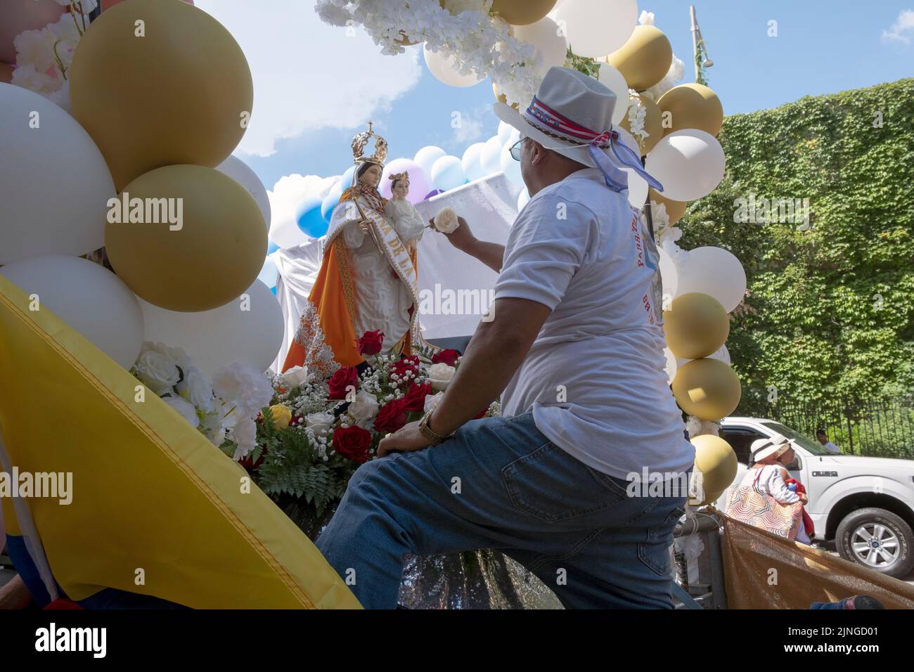 A devotee of the Virgin of the Cloud & worshipper at the Blessed Sacrament Church prepares ta float for the Ecuadorian Parade NYC 2022  in Queens NYC Stock Photo