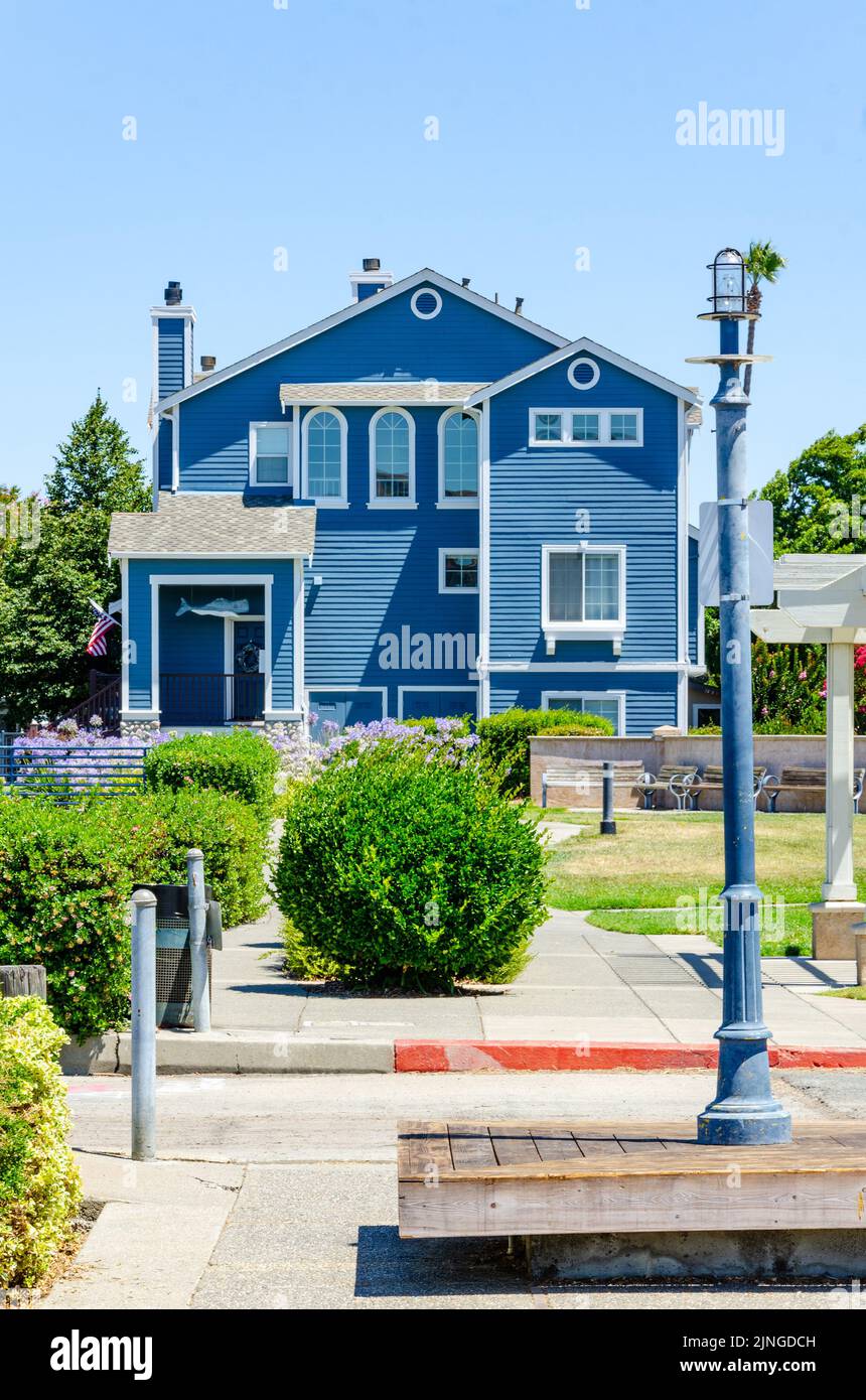 A front exterior view of a blue, wooden house at Benicia Marina in California, USA Stock Photo