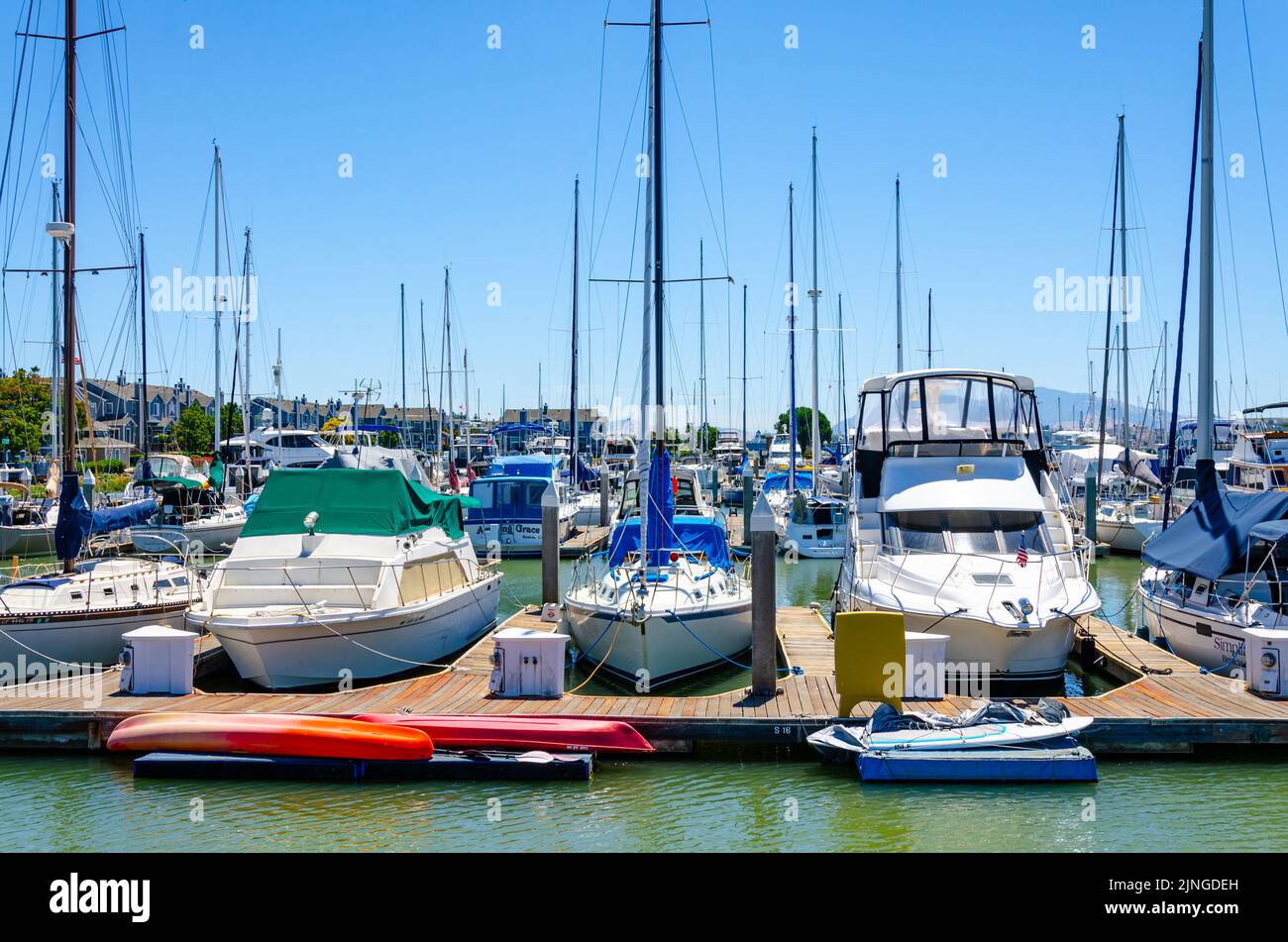 Pleasure boats moored against a pontoon in Benicia Marina in California ...