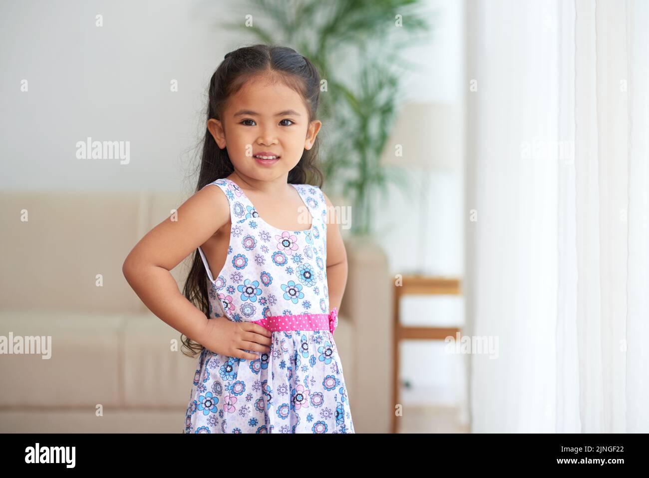 Adorable little girl in summer dress looking at camera Stock Photo - Alamy