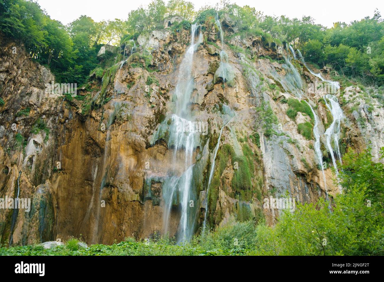 Breathtaking view of waterfall falling down from cliff. Amazing landscape with famous waterfall streams in natural park reserve on Plitvice lakes Stock Photo