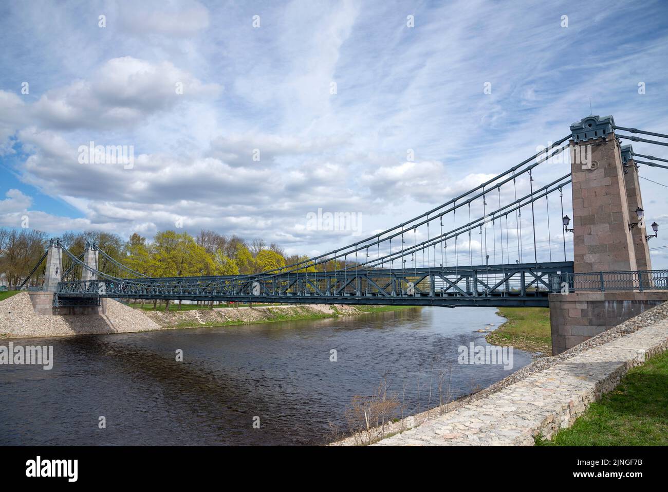 The old suspension bridge over the Velikaya River. The city of Ostrov, Pskov region. Russia Stock Photo
