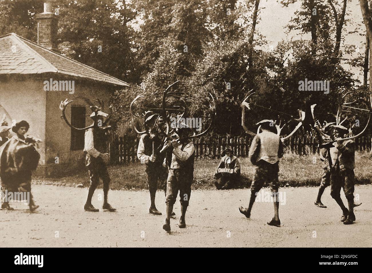 An historic newspaper photograph of Deermen (aka Deer Men) dancing the Horn Dance at Abbots Bromley, Staffordshire, England. The folk dance dates back to medieval times, though like some Morris dancing, the dance can now involve a hobby horse, Maid Marian, and a Fool. Though historical  records of the ceremony are relatively scarce,  carbon dating of the antlers used in the ceremony  date to the ceremonial aspect to the 11th century. The ceremony usually takes place on the first Sunday after 4 September. (known as Wakes Sunday) after a blessing at st Nicholas' church. Stock Photo