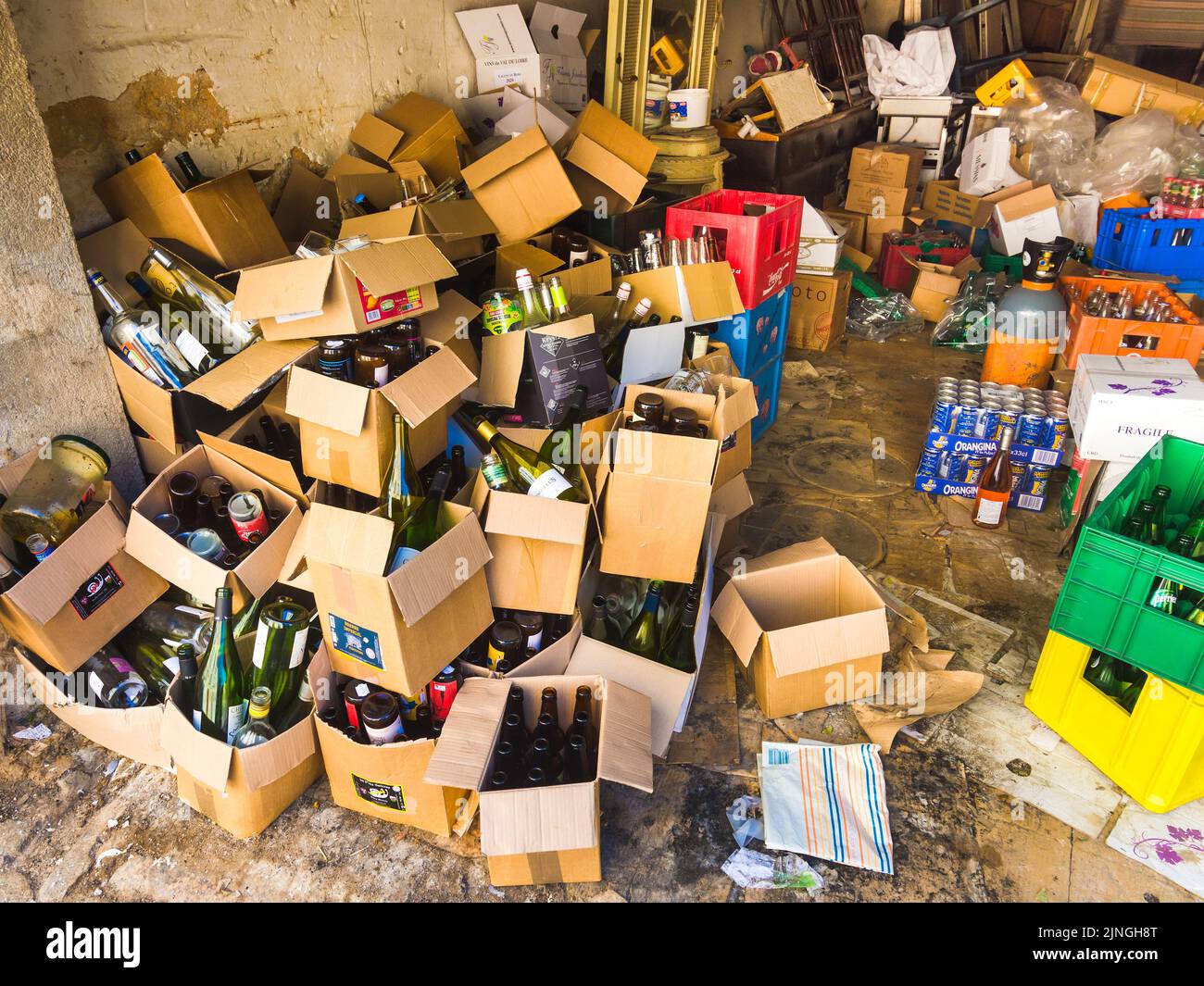 Untidy jumble of boxes and bottles of wine and beers in cellar of bar in Argenton-sur-Creuse, Indre (36), France. Stock Photo