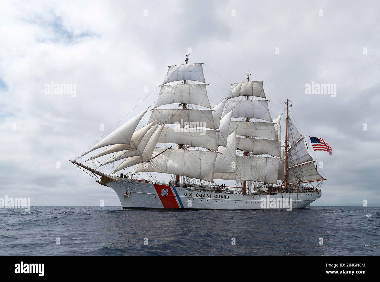 The U.S. Coast Guard cutter USCGC Eagle tall ship displaying full sails as it departs for the Atlantic Ocean, July 2, 2019 off the coast of the Azores. Stock Photo