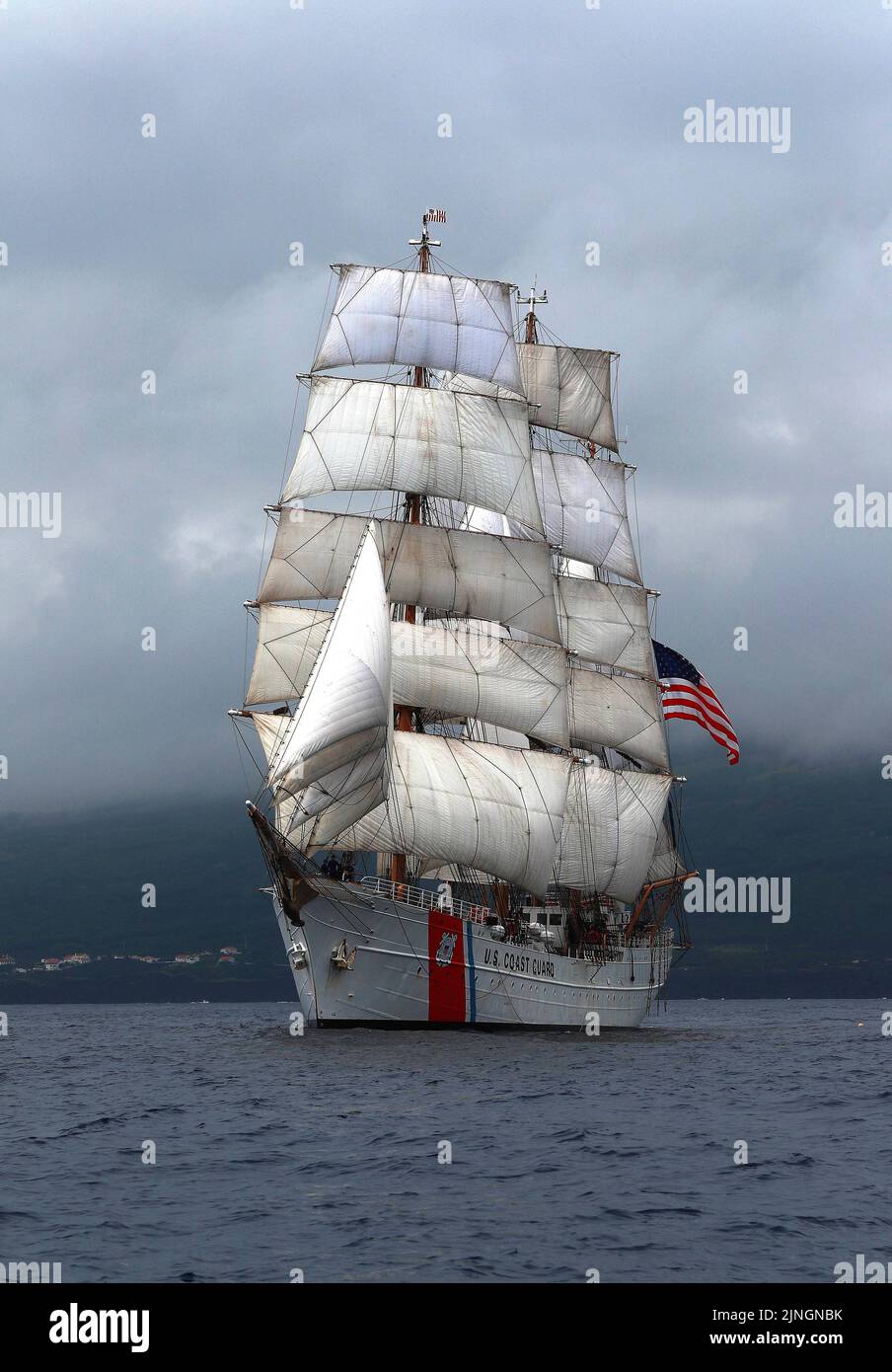The U.S. Coast Guard cutter USCGC Eagle tall ship displaying full sails as it departs for the Atlantic Ocean, July 2, 2019 off the coast of the Azores. Stock Photo