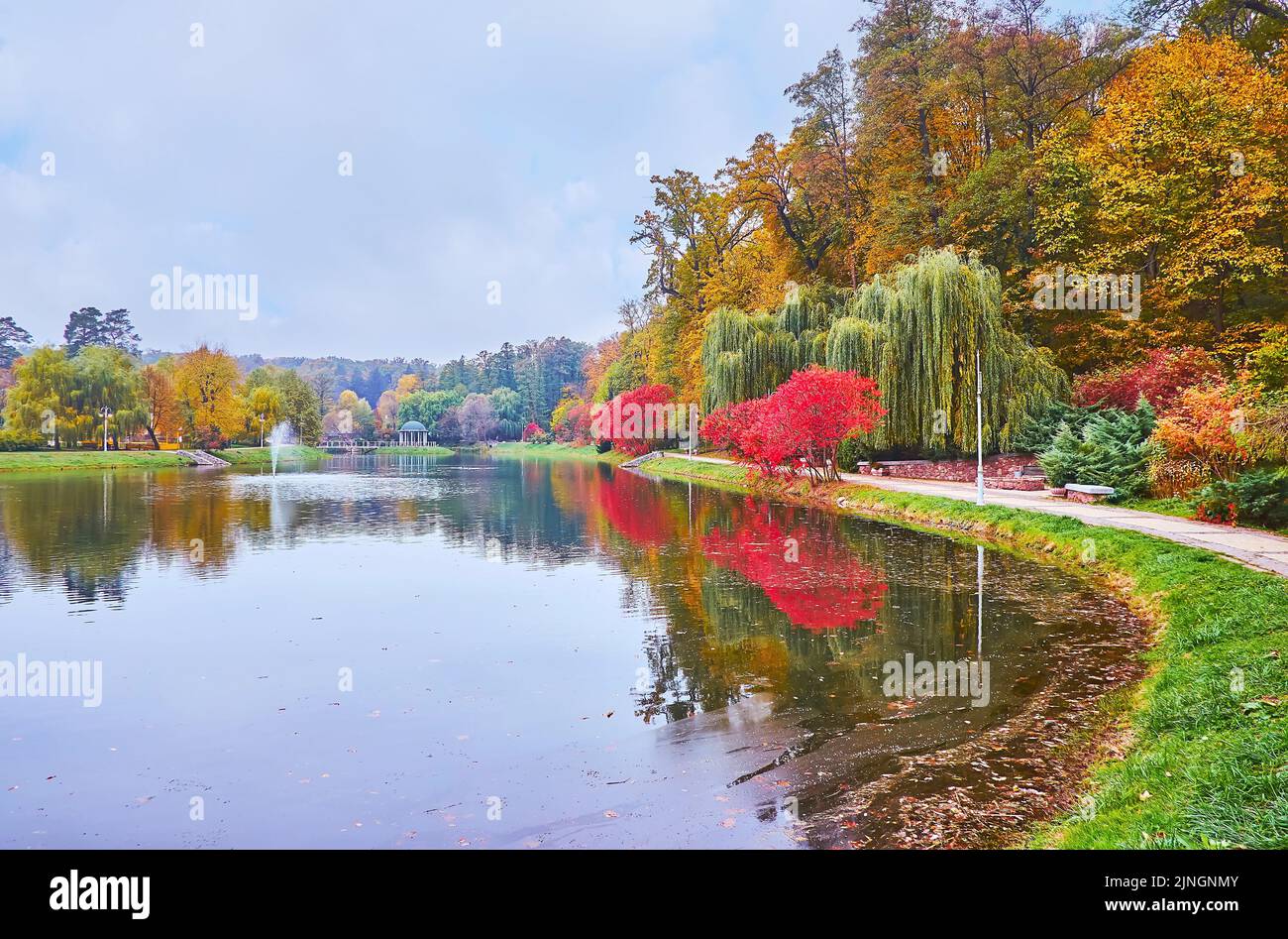 The scenic autumn Feofania park with Palladin pond with a fountain and a small gazebo in background, Kyiv, Ukraine Stock Photo